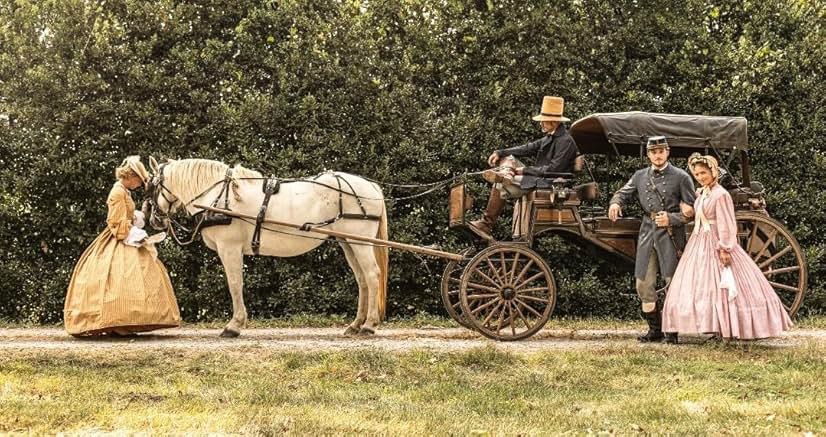 Bride and groom by elegant white carriage